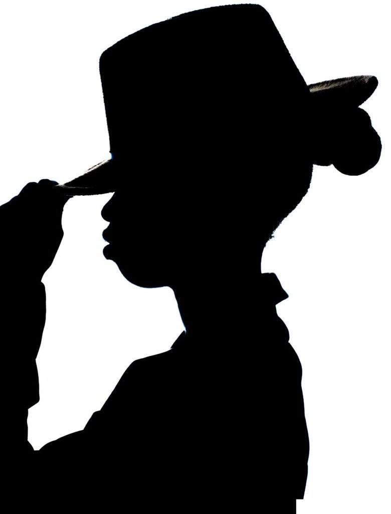 pexels-photo-35680735-35680735 Elegant black silhouette of a person tipping a hat on white background.